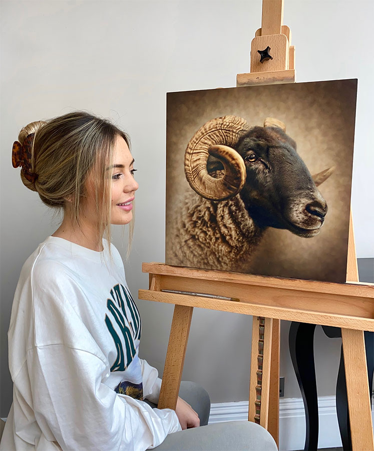 Charlotte Gridley with painting of a ram.